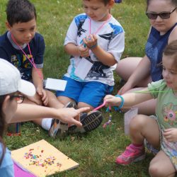 Red group working on friendship bracelets