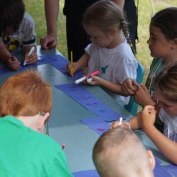 Orange group creating a paper chain of friendship